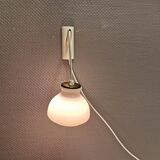 Milky white Holmegaard wall lamp with glass shade and a brass detail on top. Wooden wall bracket