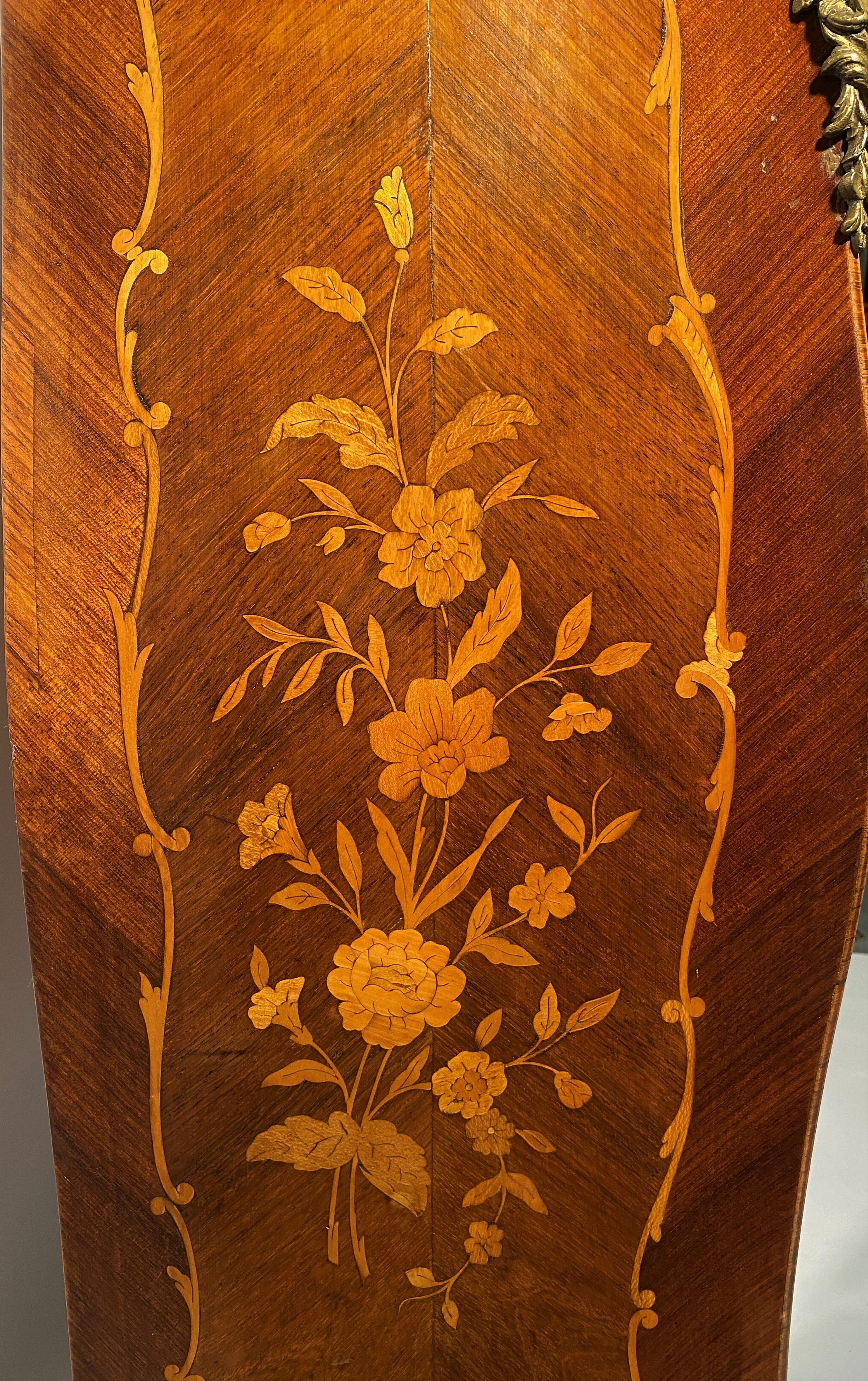 Curved secretary and inlaid with floral branches in Louis XV style