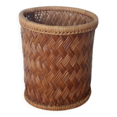 Tall cylindrical wicker basket, plant pot or waste paper basket.