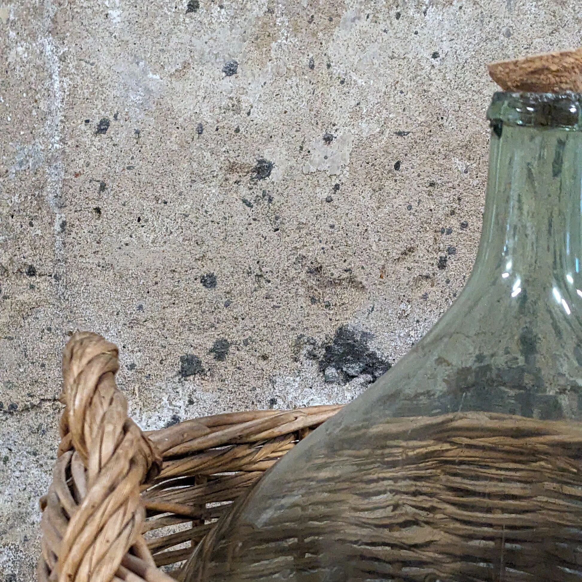 Demijohn in its wicker basket