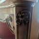 Antique corner cabinet in Louis XV style, topped with a marble surface.