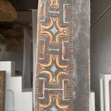 Indonesian construction element in carved wood with cross pattern in red, white geometric frieze