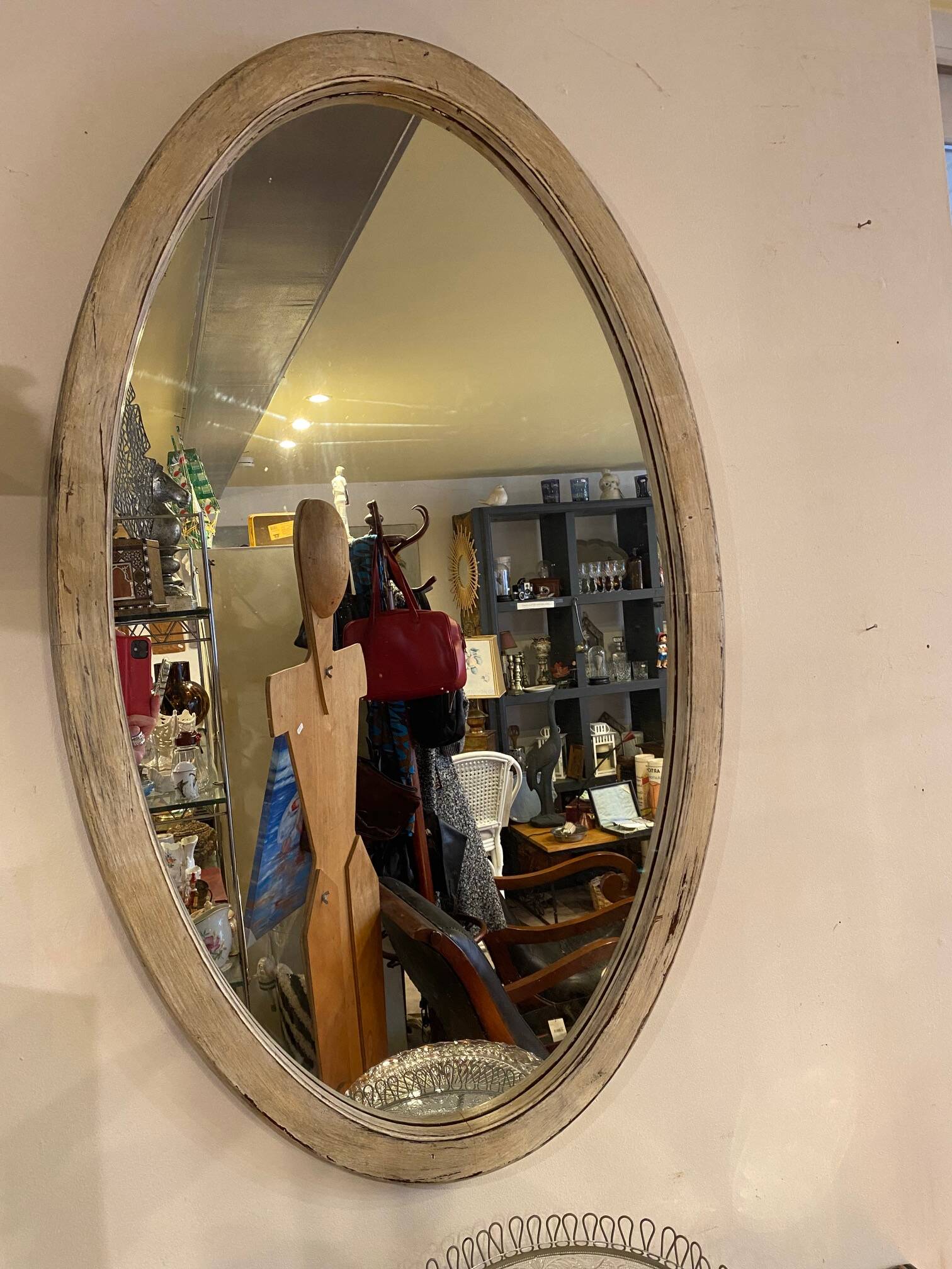 Large old oval mirror with beige patina wooden frame early 20th century