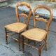 Two Louis Philippe cane chairs in solid carved wood from the 20th century