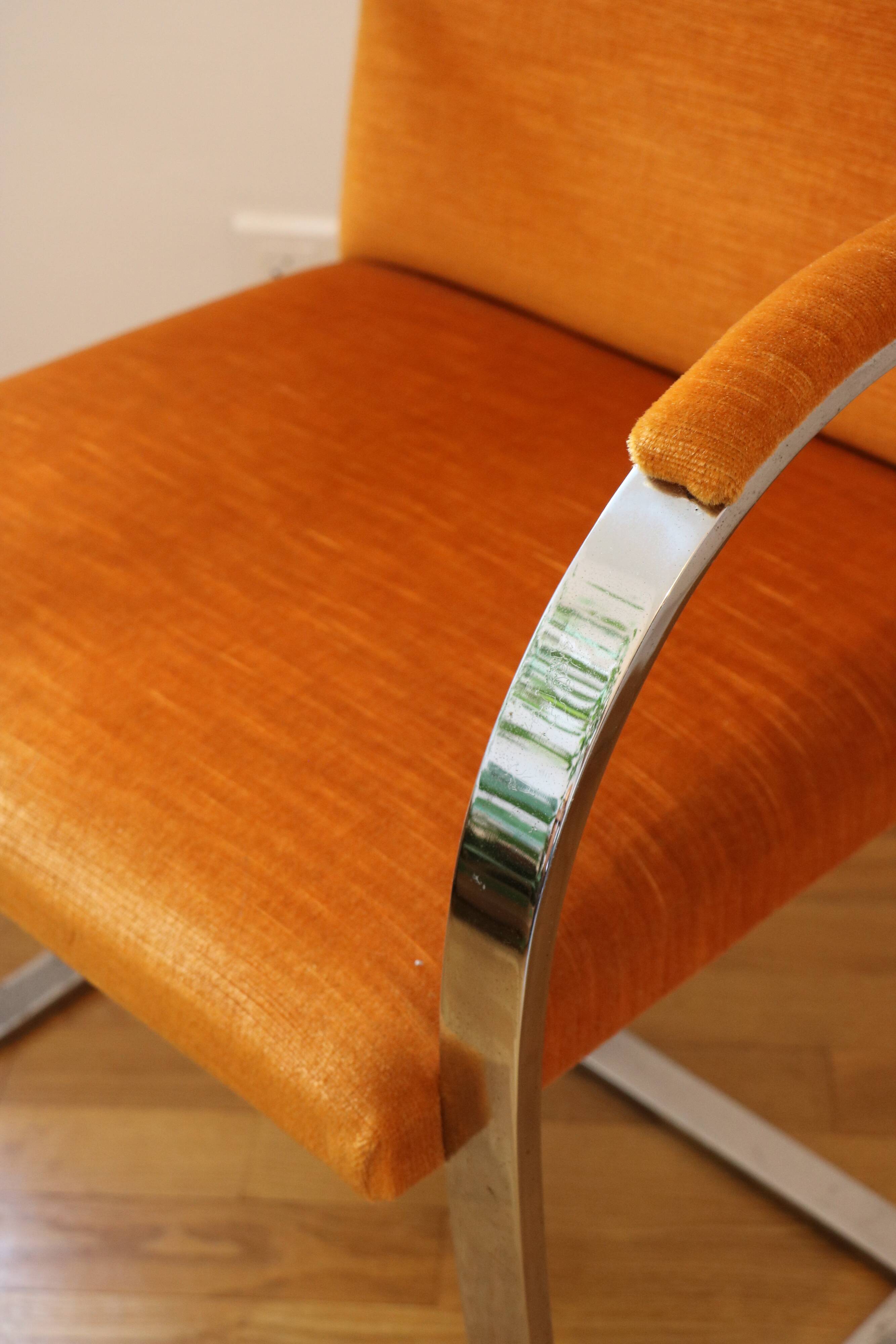 Chrome-plated metal and orange fabric armchair, 1970