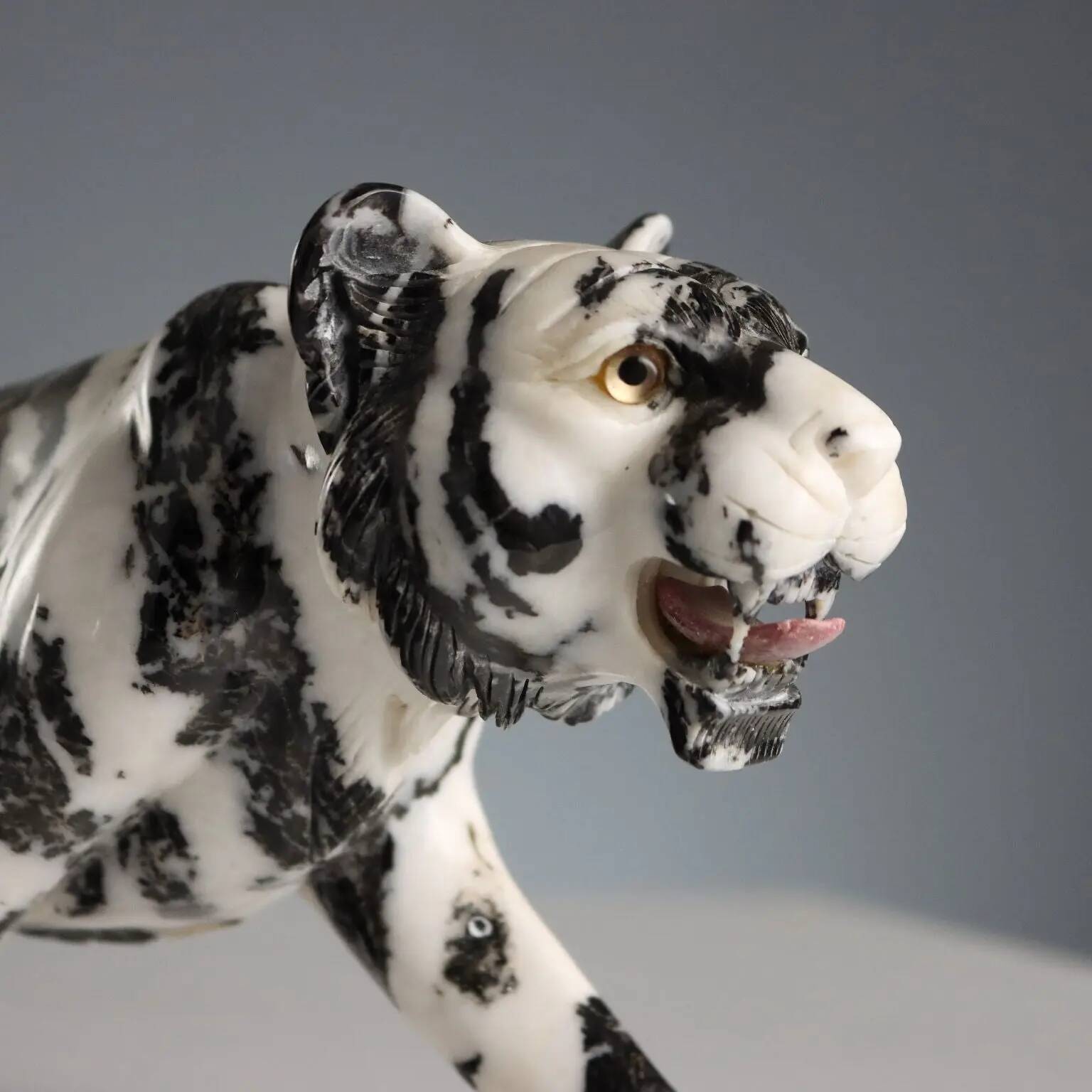 Ancient sculpture of a black and white marble panther, 20th century.