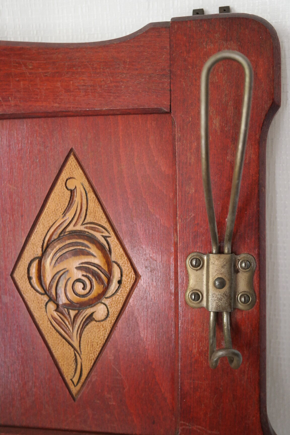 Red wooden wall-mounted coat rack and Art Deco mirror