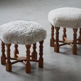 Pair of mid-century Danish oak stools with shearling lambswool upholstery, 1950s.