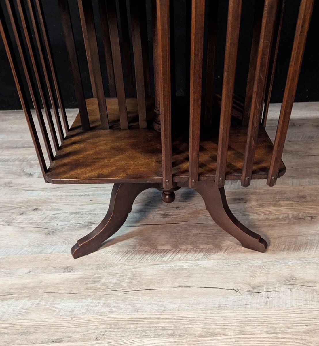 Rotating walnut library with a marble top.