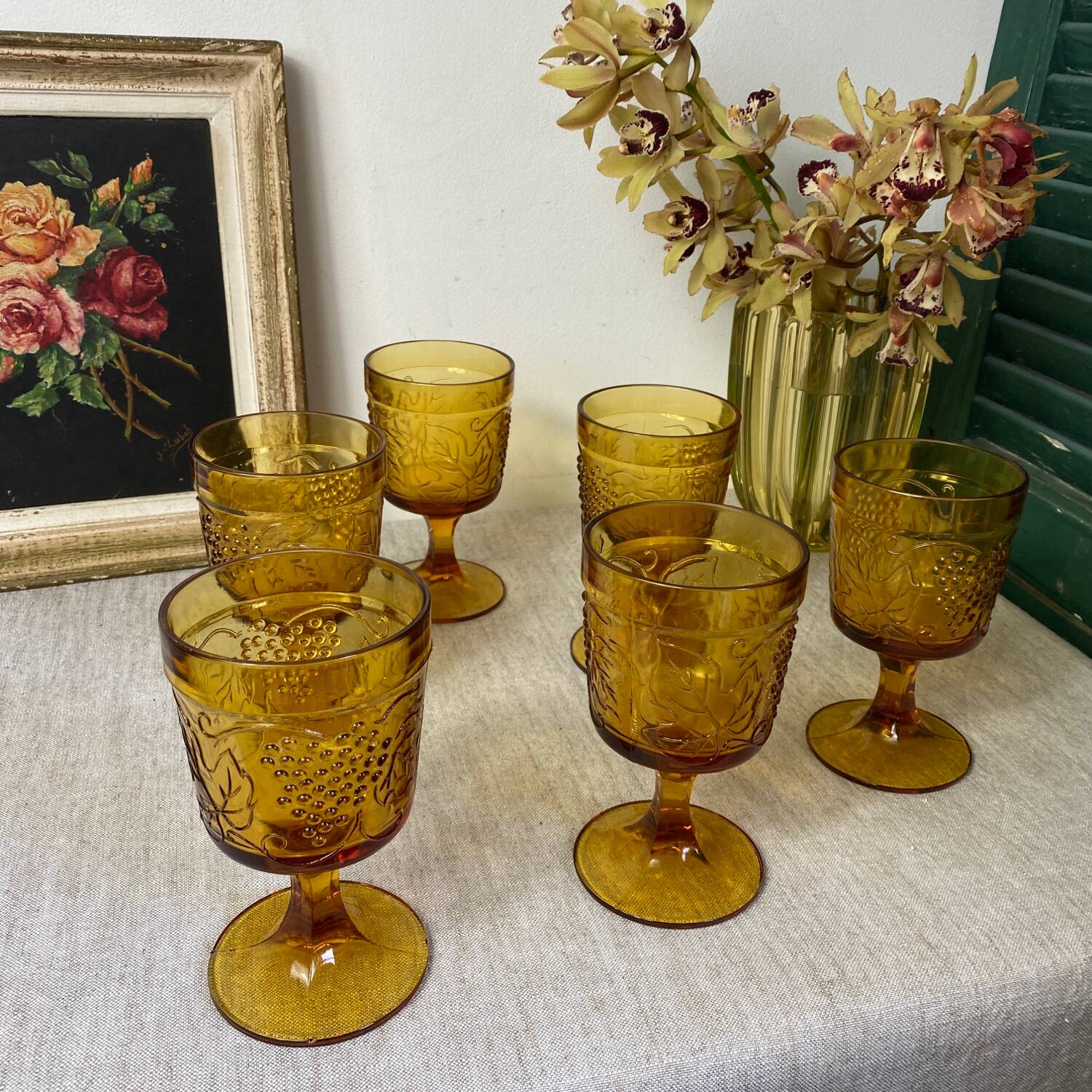 Six amber-colored stemmed glasses