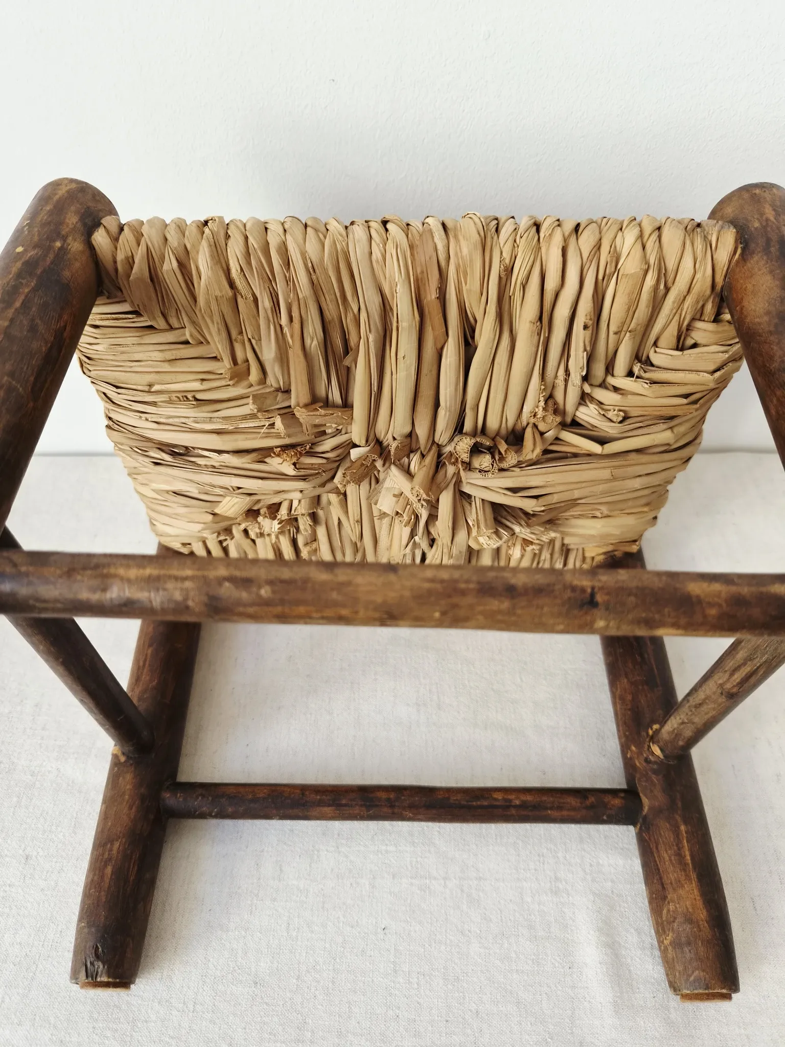 Small rustic vintage wooden and straw stool -
