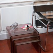 Vintage trio of nesting tables in smoked plexiglass by Michel Dumas, year.