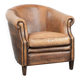 Club chair made of sheepskin leather finished with decorative nails