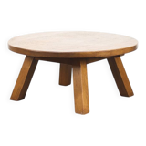 Large rustic vintage coffee table in a round brutalist style.