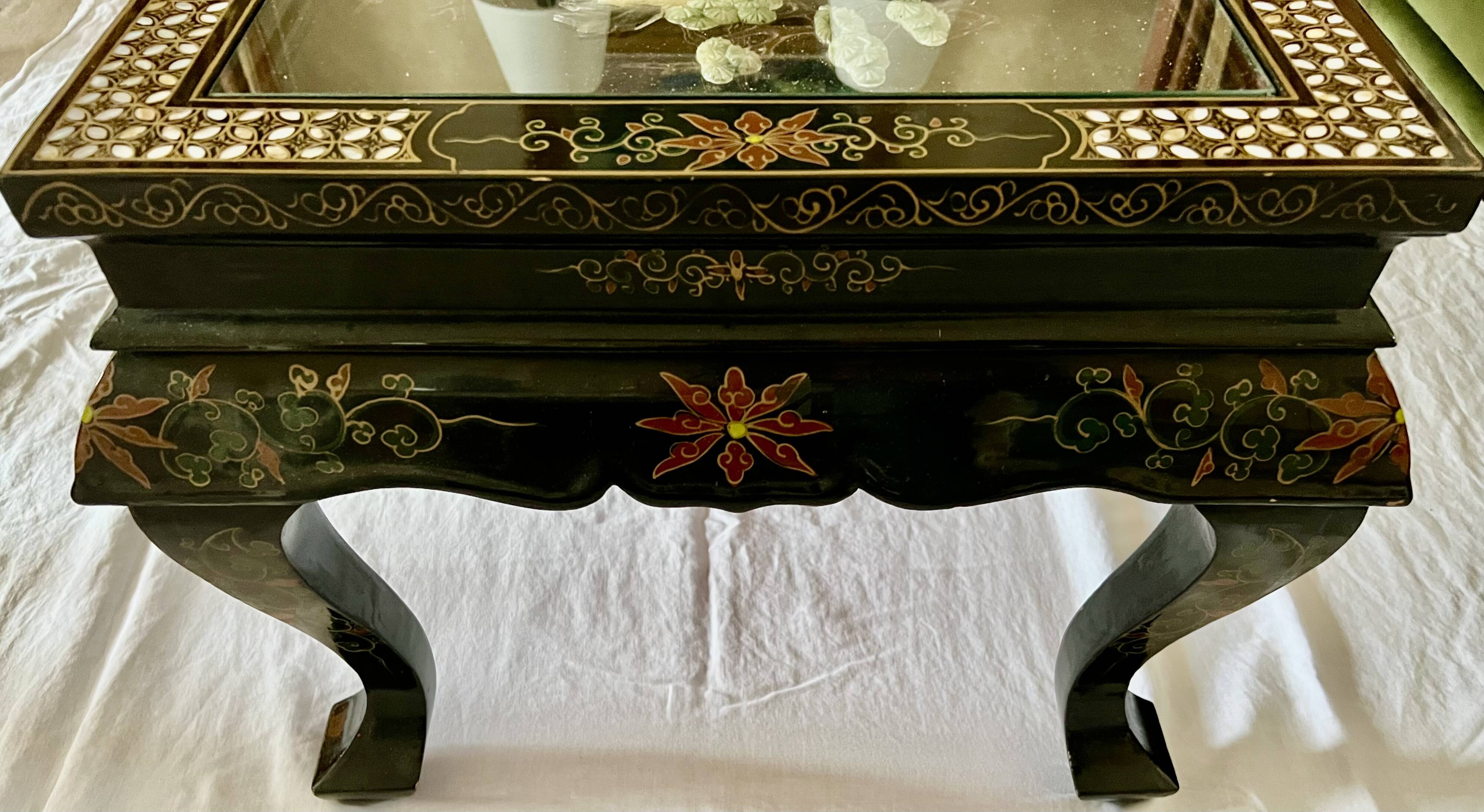 Chinese black wood table inlaid with mother-of-pearl featuring a relief scene of a crane.