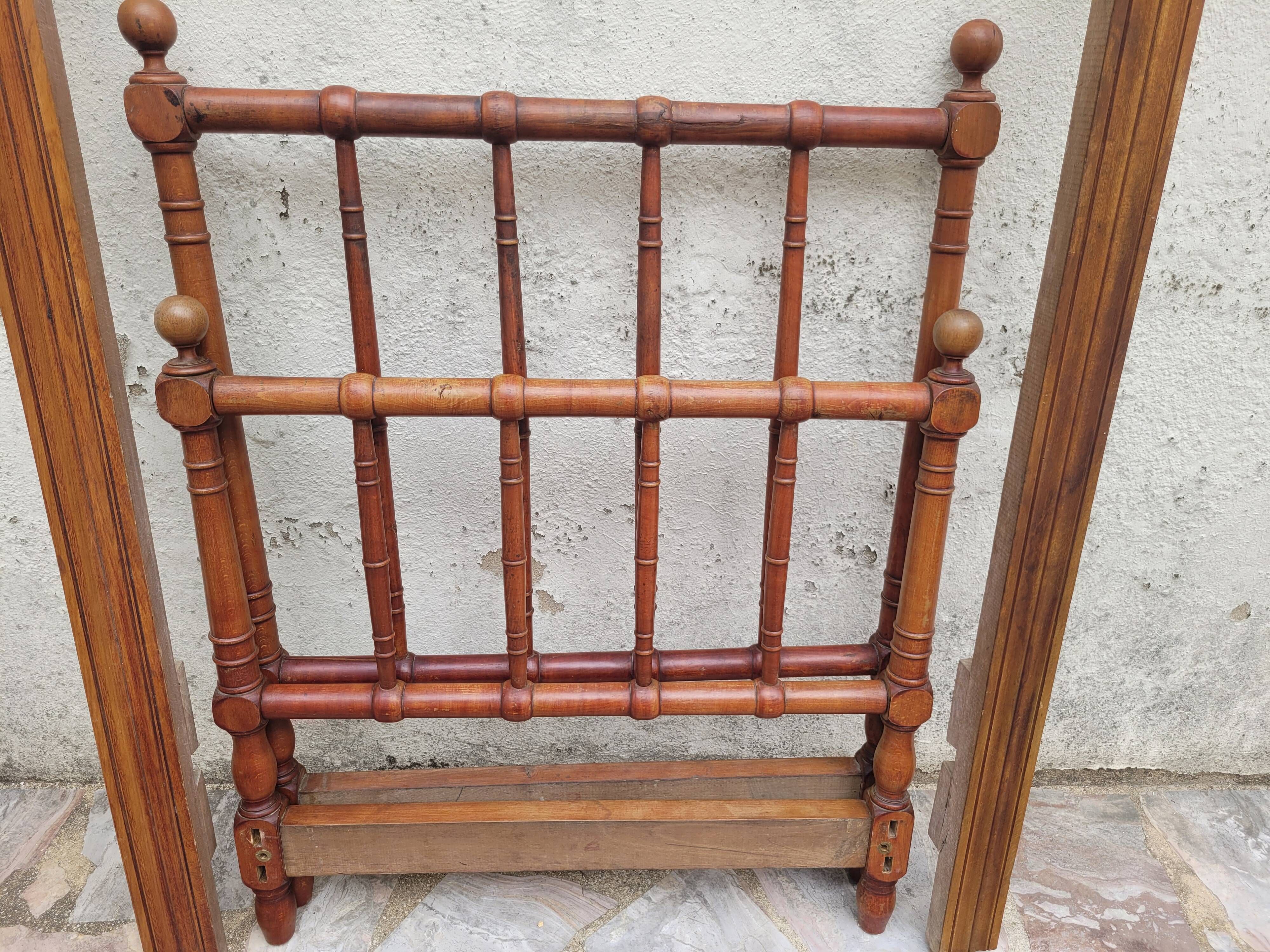 Child's bed or vintage rest bed made of solid cherry wood in a bamboo style.