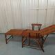 Sunbathing sunbathing in wicker rattan wood deckchair red lounger