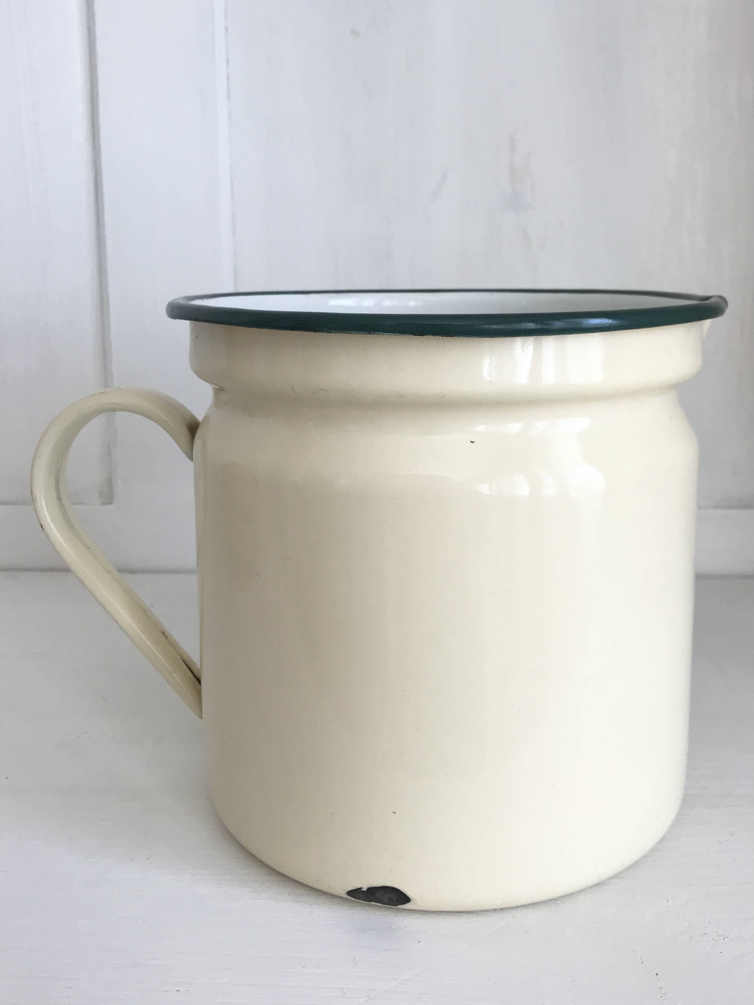 Old milk jug in enameled sheet metal