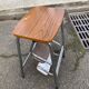 Folding stool in formica with a wood effect.