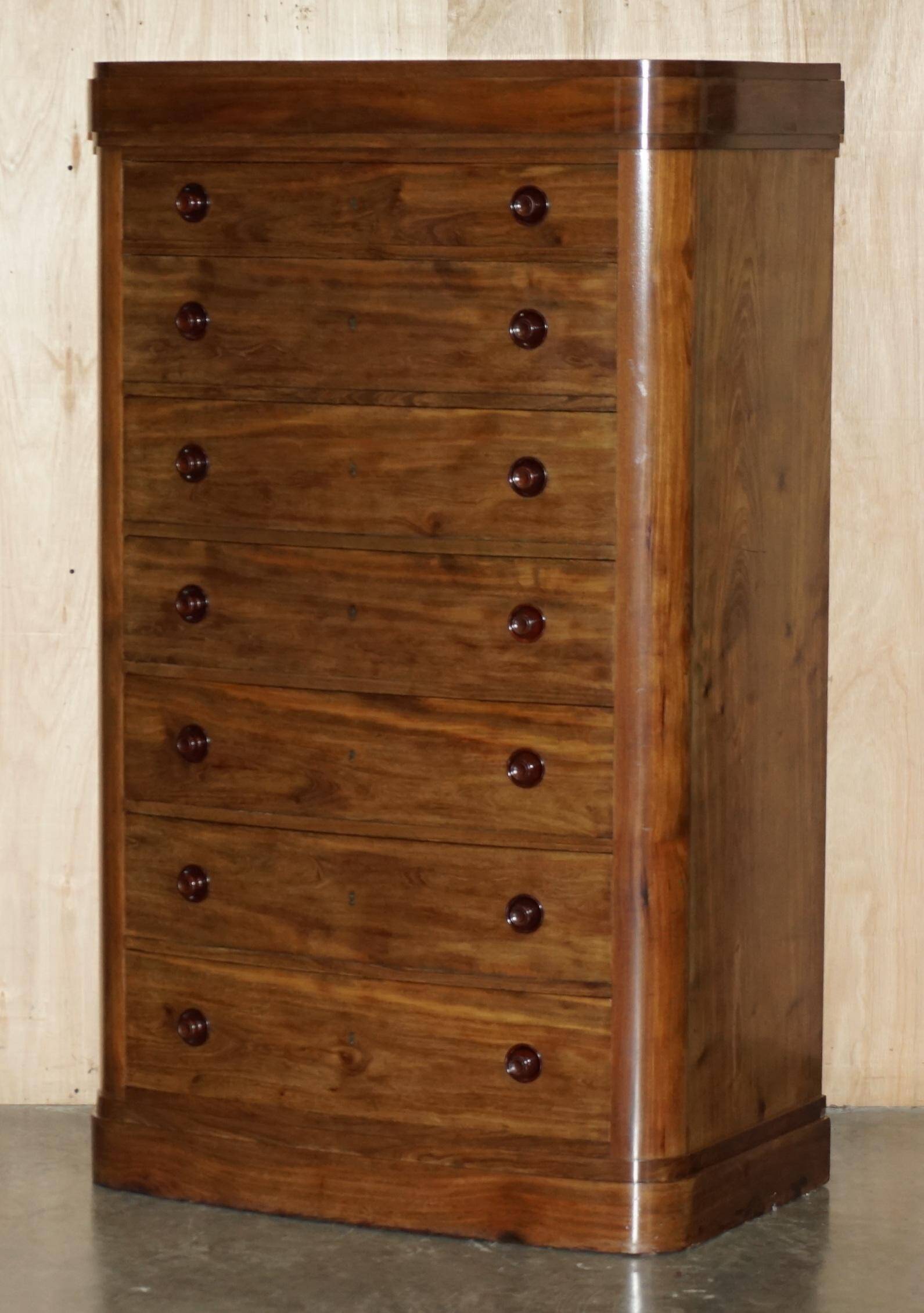 Pair of tall walnut chests of drawers with curved fronts in country style.