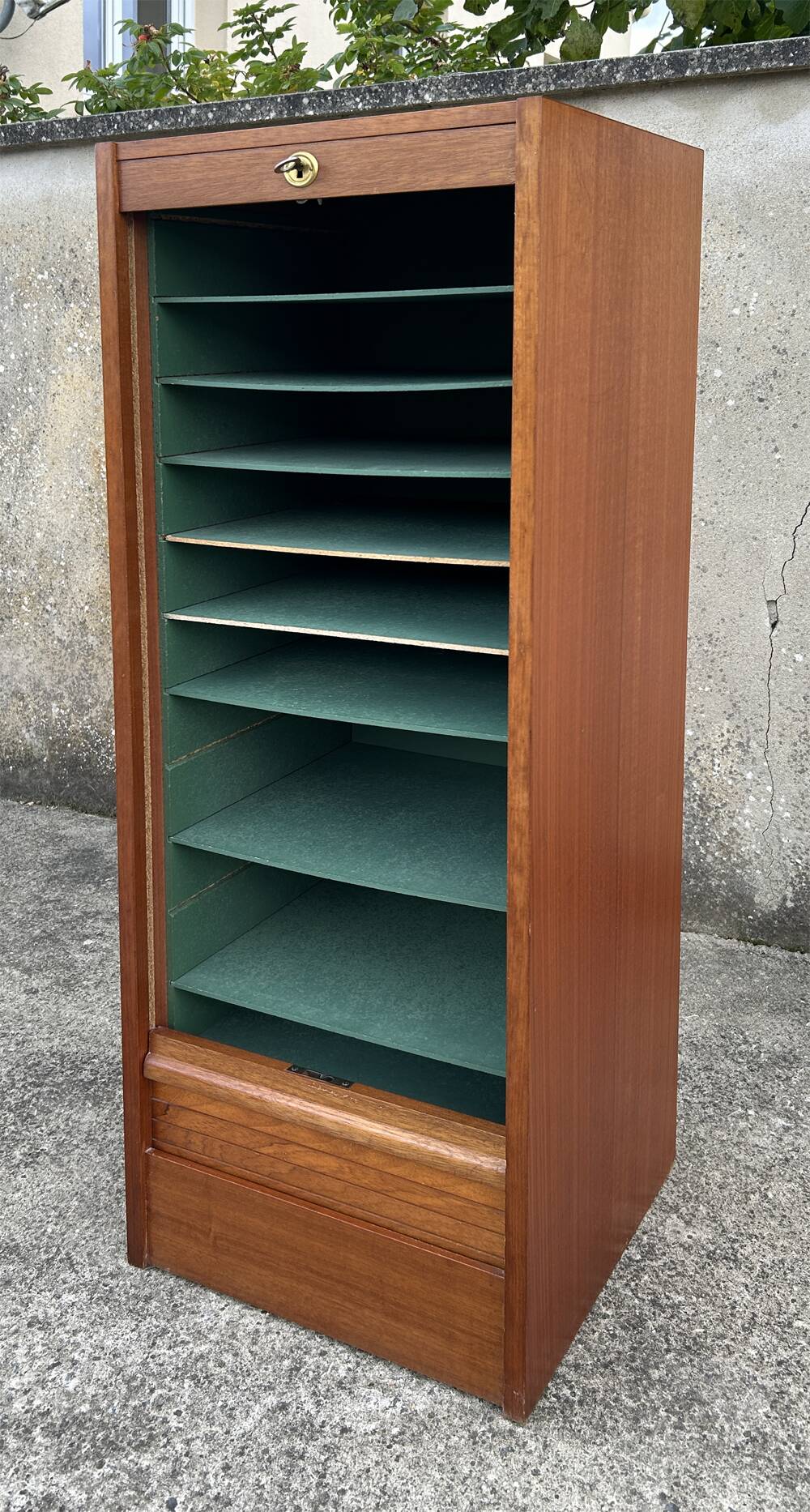 Vintage wooden filing cabinet with curtains.