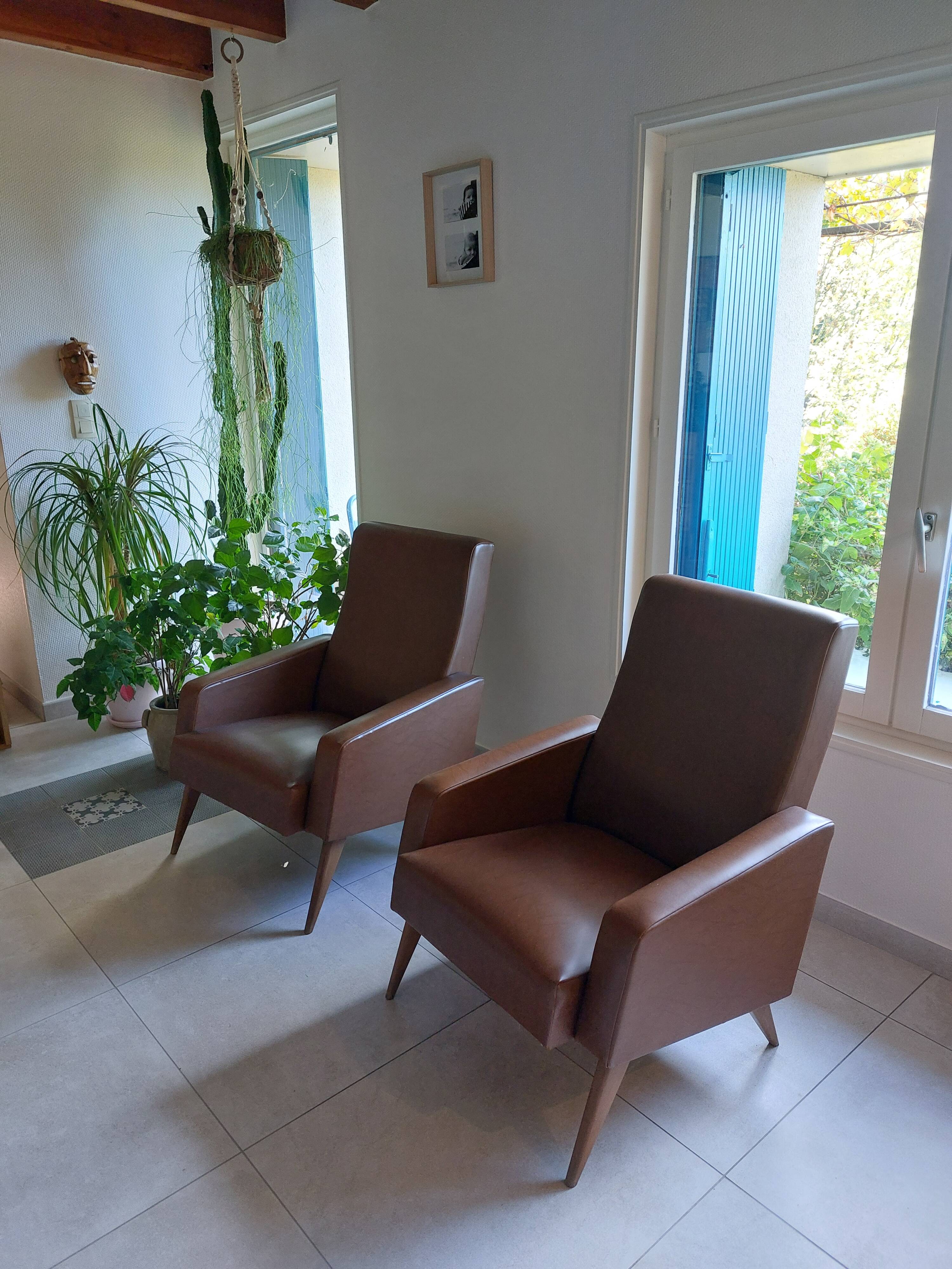 a pair of comfortable vintage armchairs with splayed legs