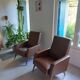 a pair of comfortable vintage armchairs with splayed legs