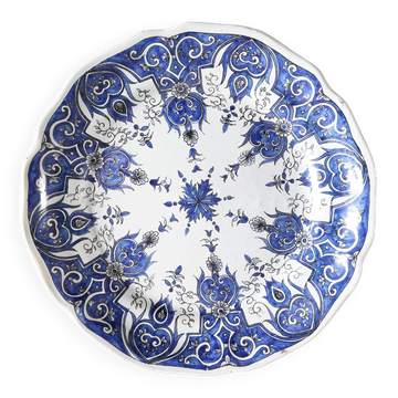 Hand-painted earthenware plate in blue tones.
