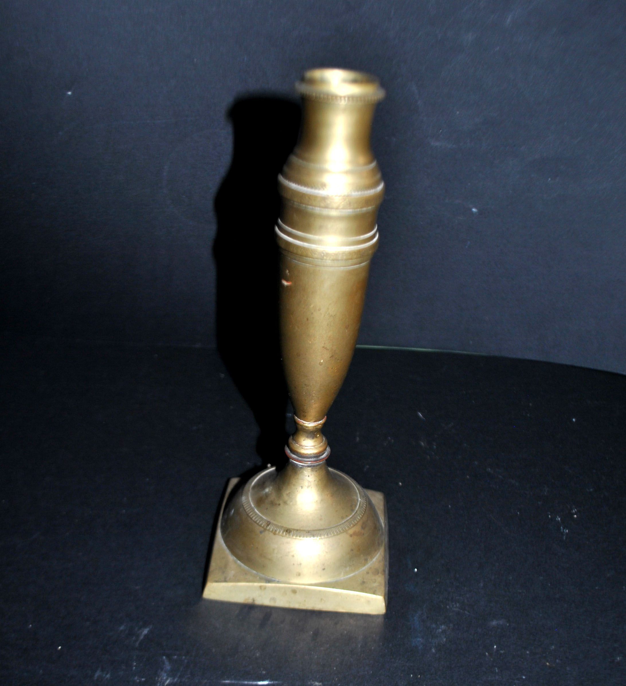 Antique baluster candlestick in bronze with hand-chiseled design.