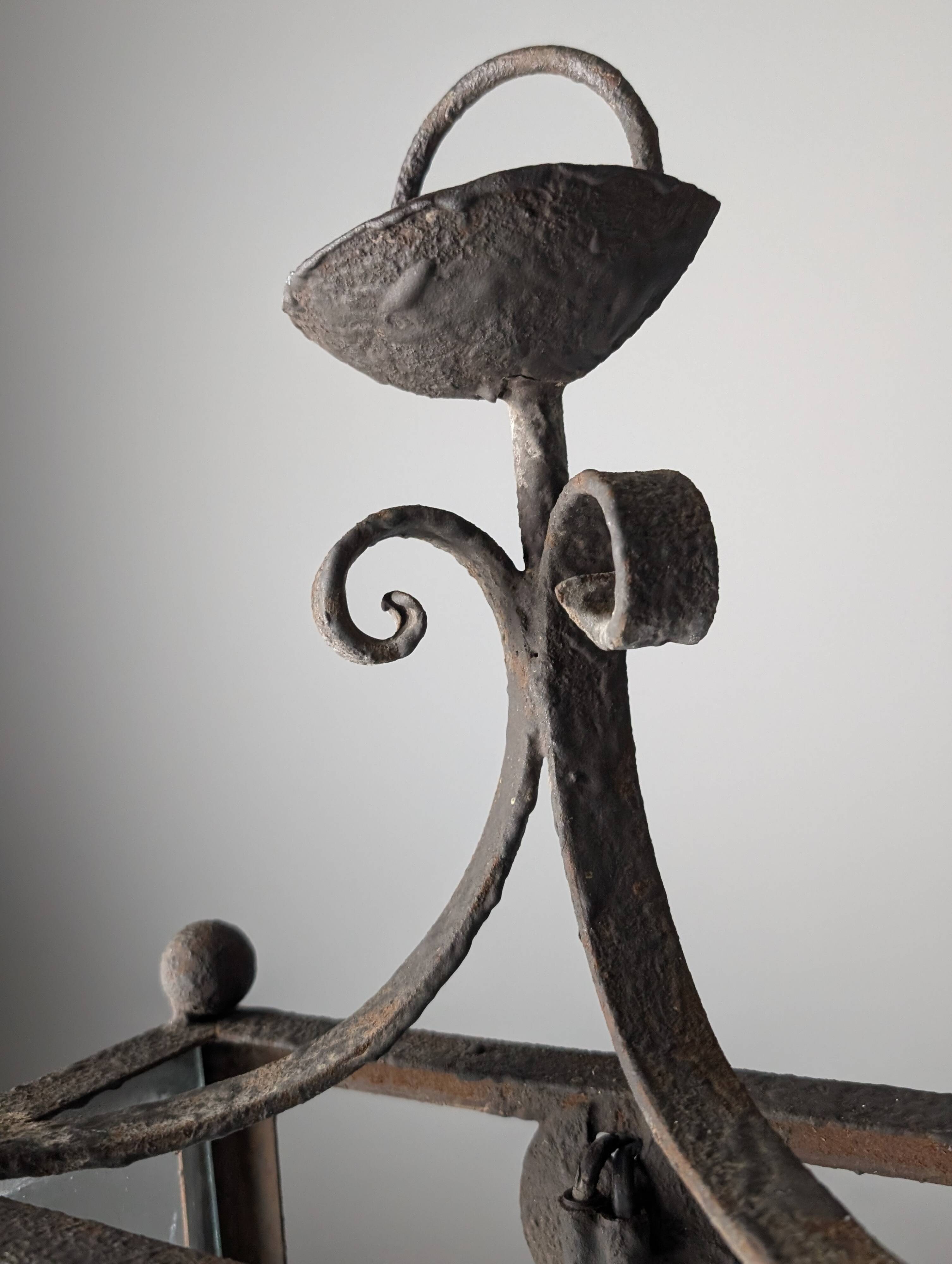 Wrought iron lantern with glass panels, leaf motifs