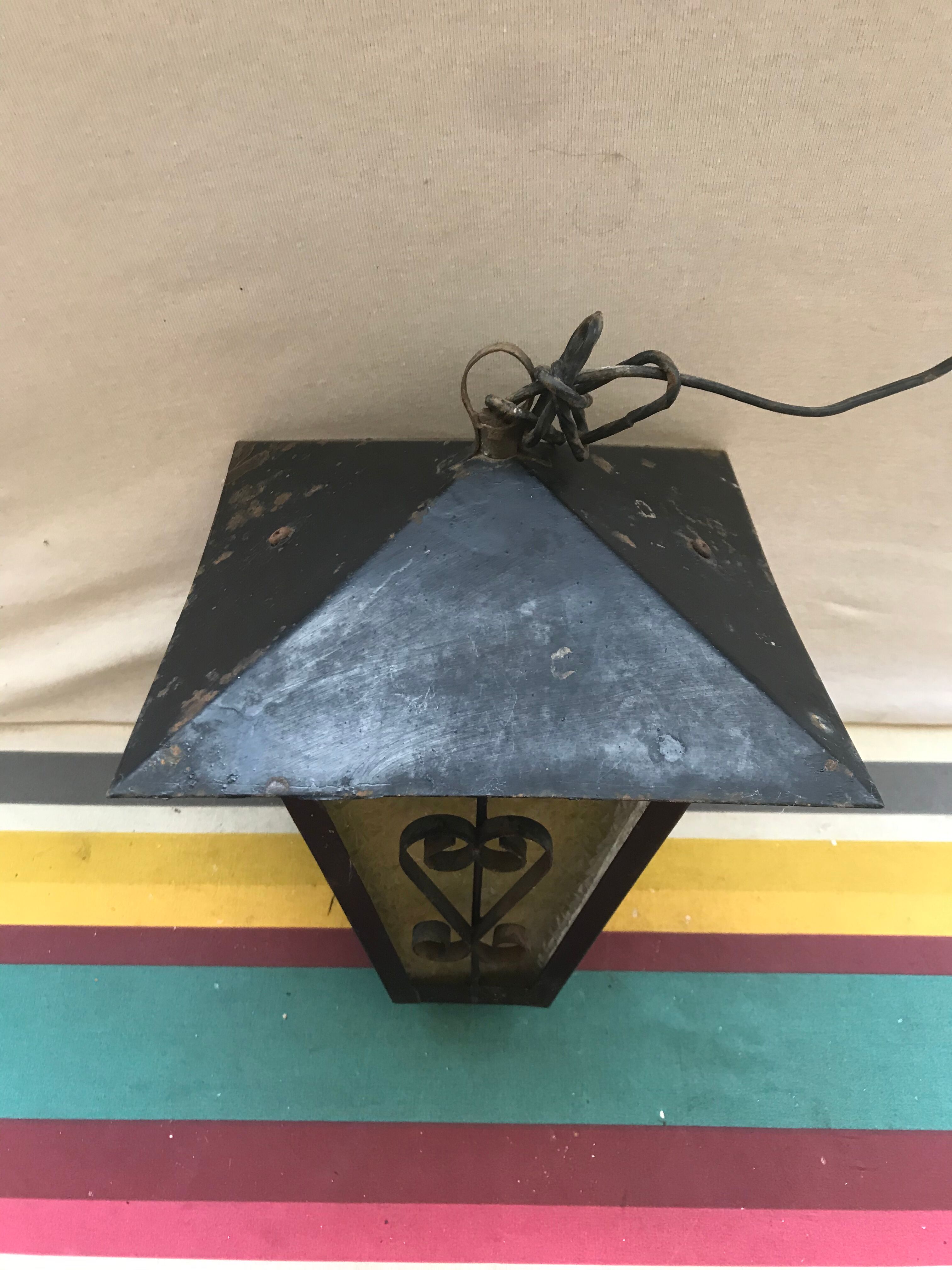 Old black forged iron suspension vintage in moulded glass