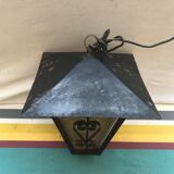 Old black forged iron suspension vintage in moulded glass