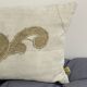 Cushion in vintage fabric with ornamentation.