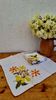 Set of 8 vintage 1970s table napkins with orange and yellow flowers.