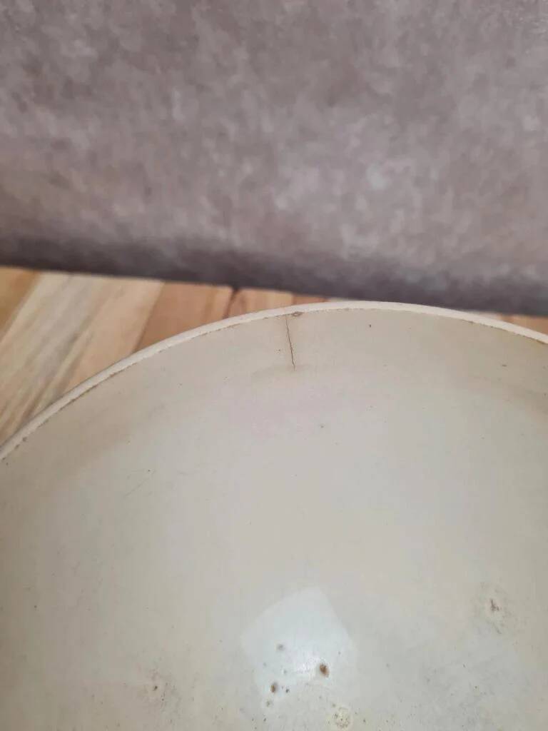Old ironstone bowl with vintage blue and ochre decoration.
