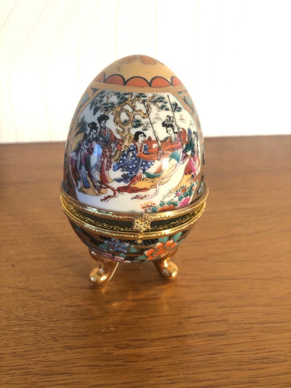 Egg-shaped porcelain jewelry box with asisaisues motifs