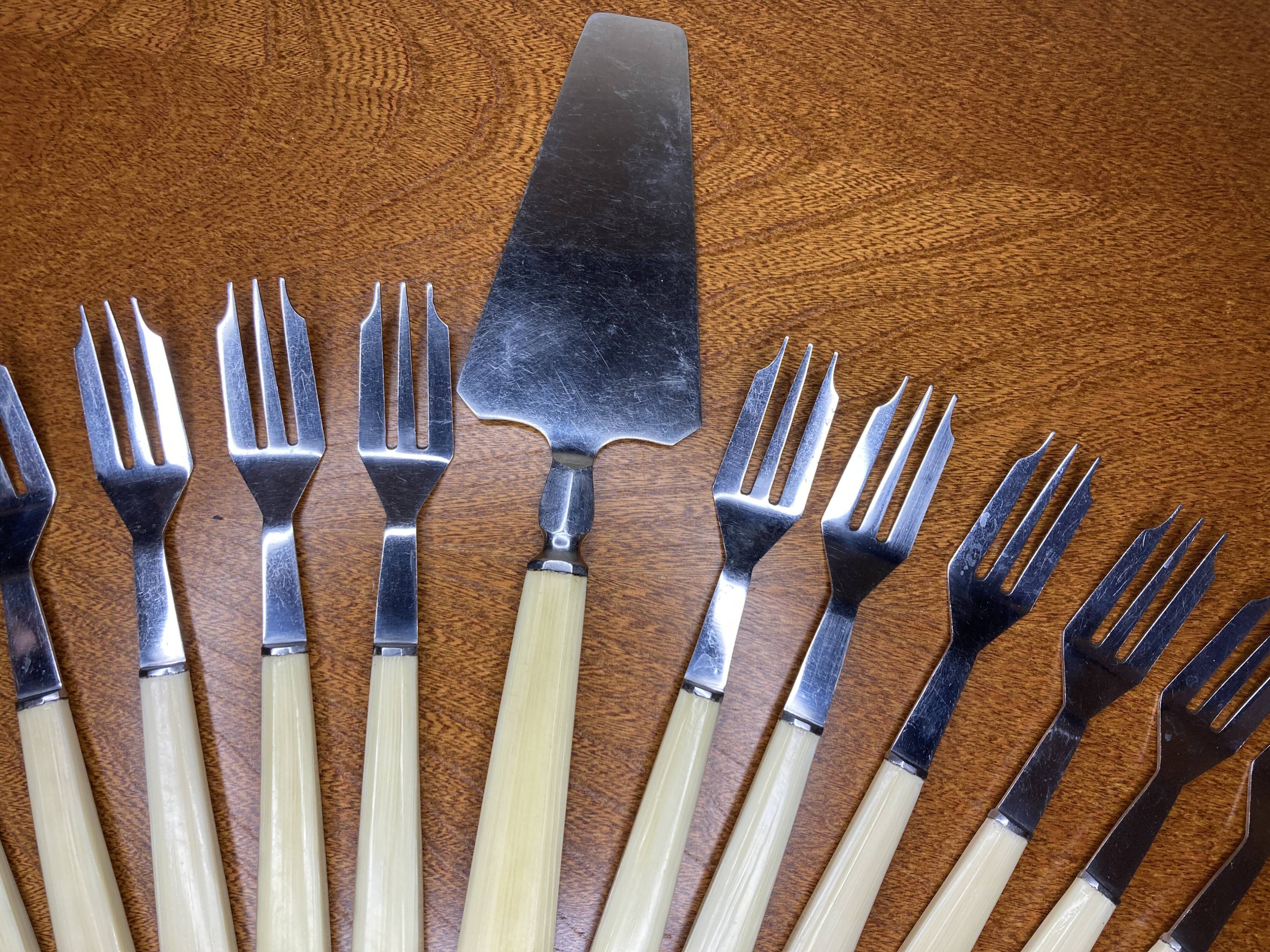 12 dessert forks and stainless steel pie shovel and ecru Bakelite handle