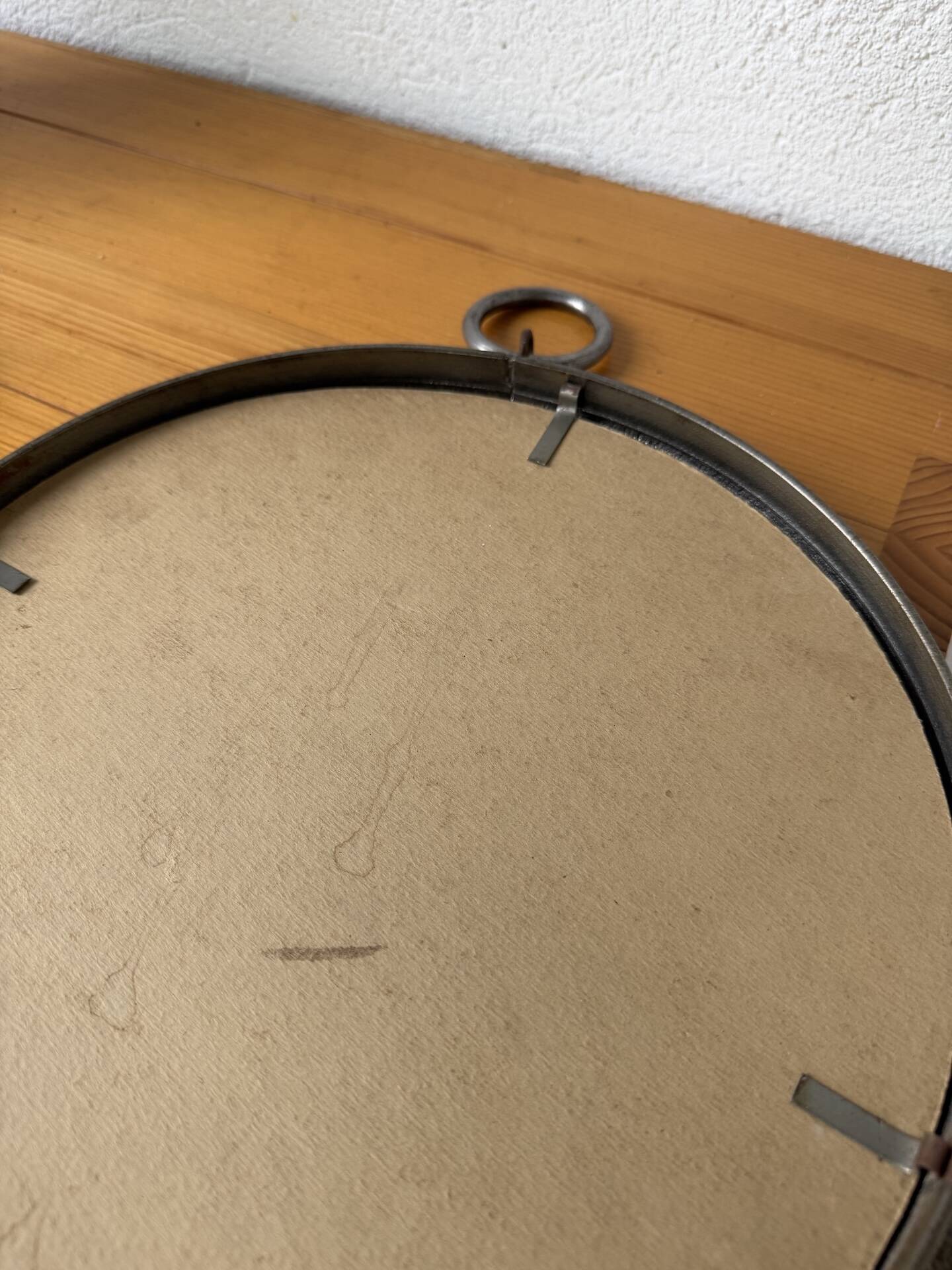 Brutalist round mirror with wrought iron and studs.