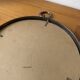 Brutalist round mirror with wrought iron and studs.