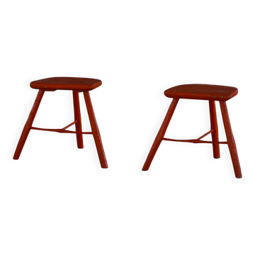 Pair of patinated wooden stools painted red with flared legs, 1950s-1960s.