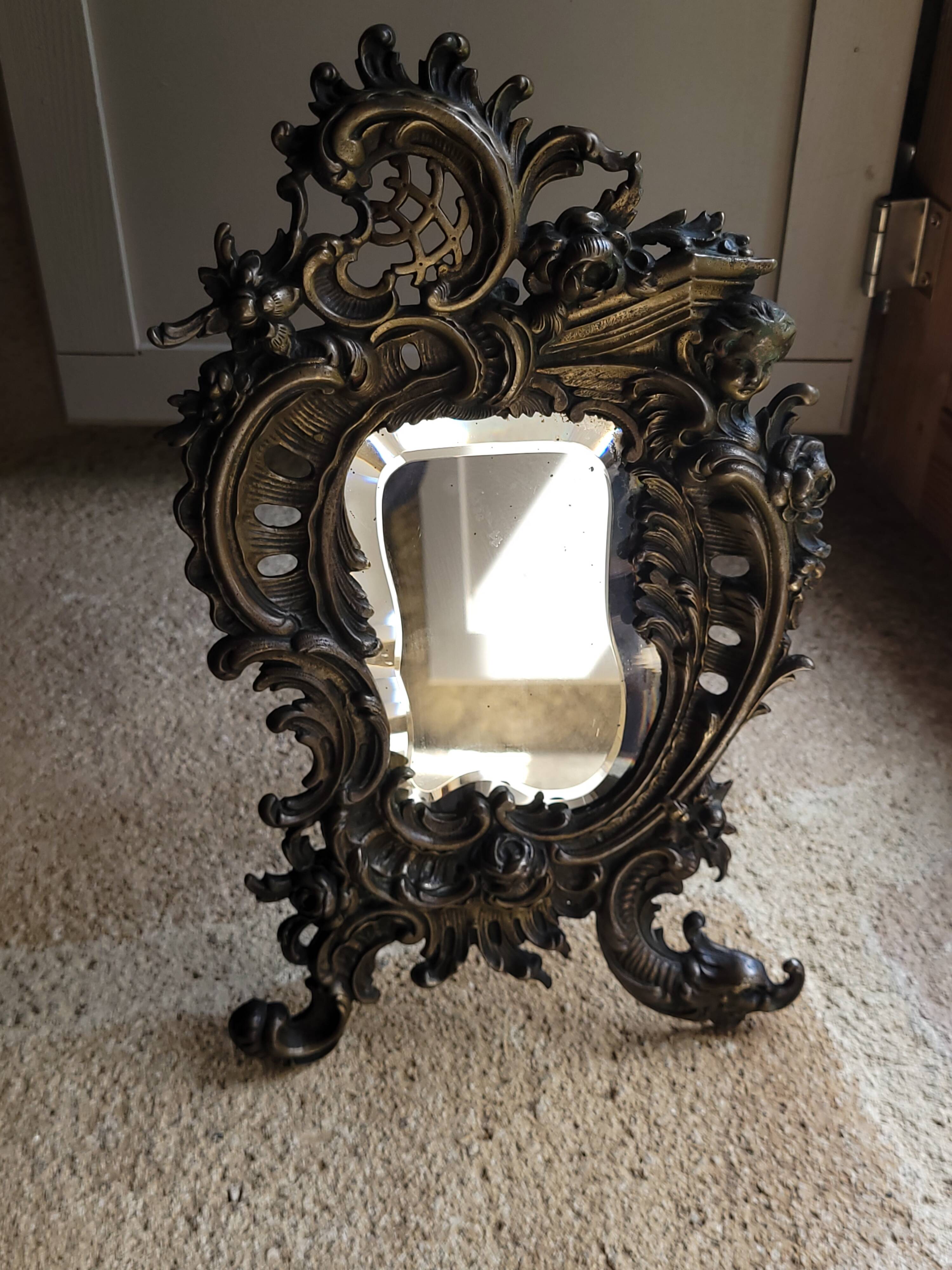 Antique bevelled bronze table mirror on stand, late 19th century.