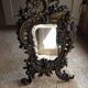 Antique bevelled bronze table mirror on stand, late 19th century.