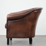 Great luxurious brown cowhide club armchair with matching piping