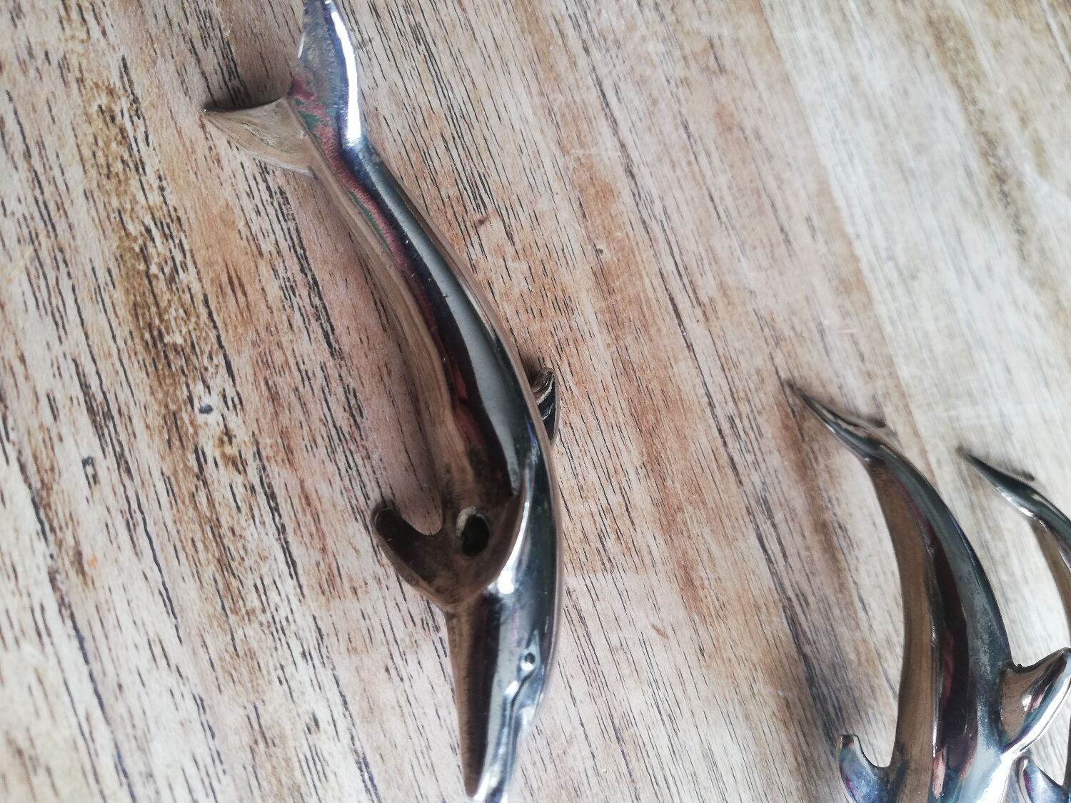Set of three silver metal dolphin place markers