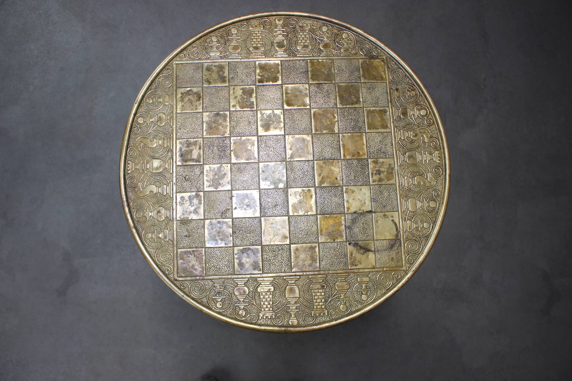 Art Deco chess table from the 1930s with a hand-decorated brass top and a stained oak base.