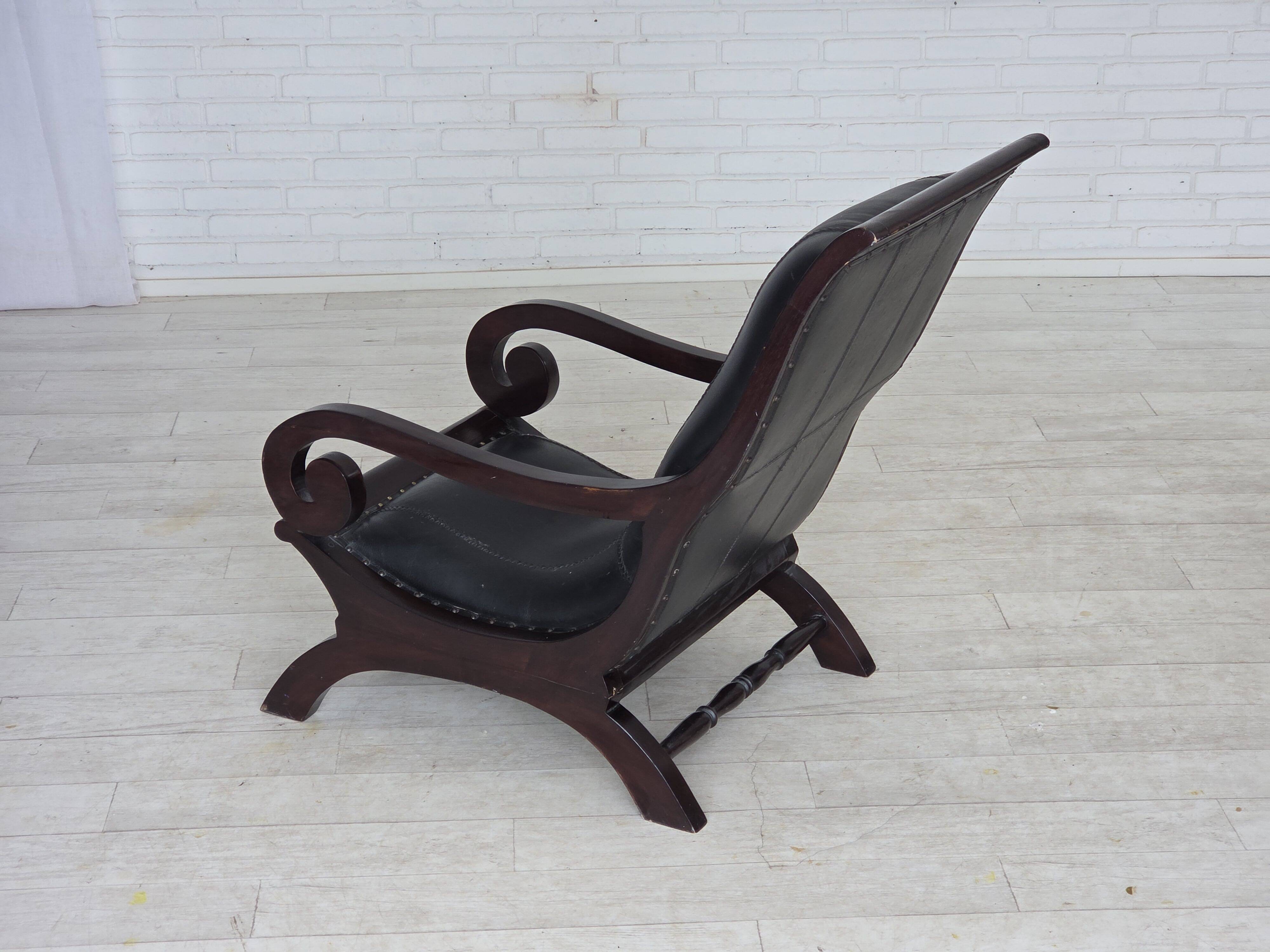 1970s, vintage armchair with footstool, black furniture leather.