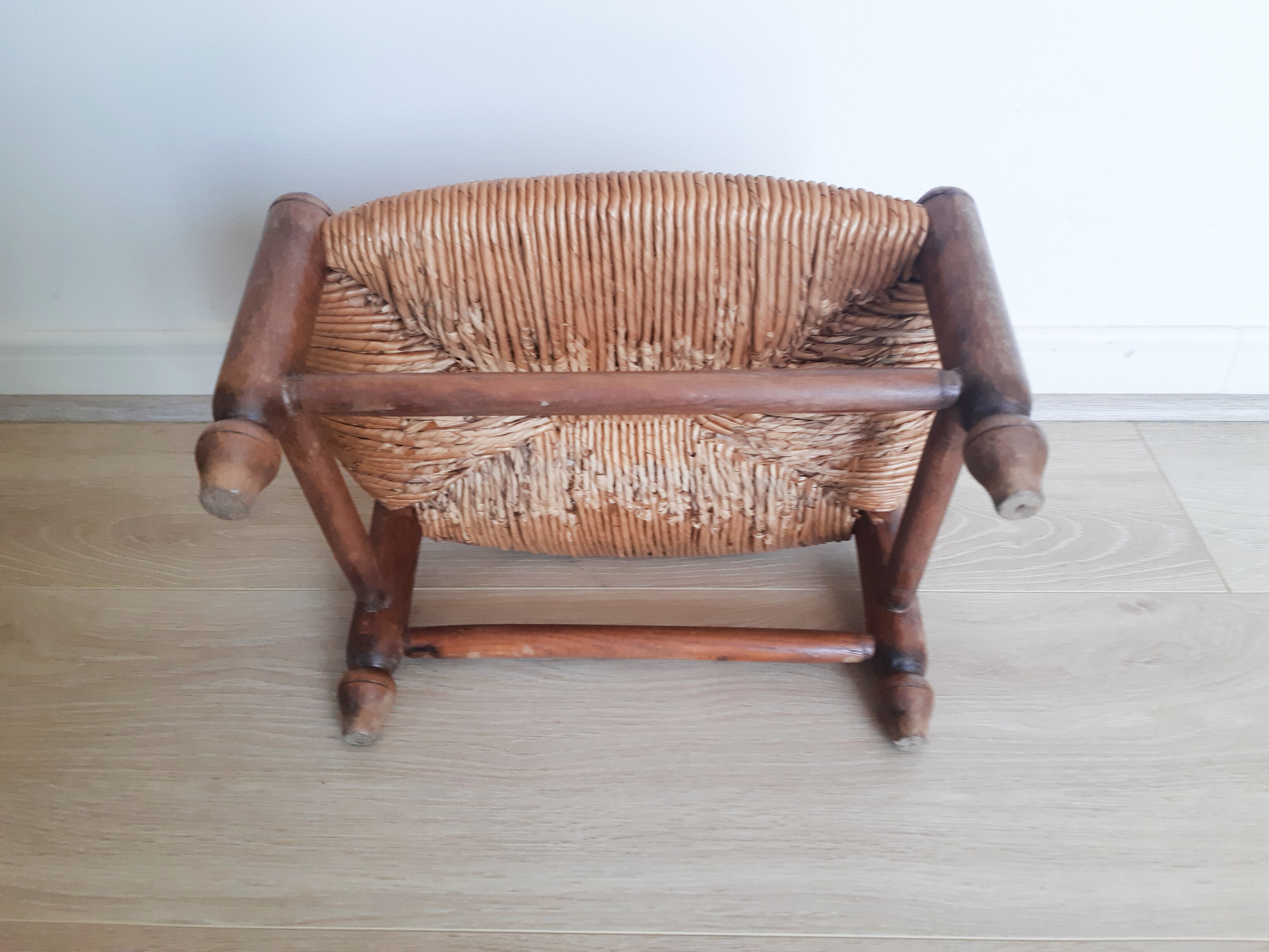 Low wooden stool and straw