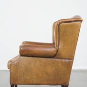 Patinated sheep leather wingback armchair