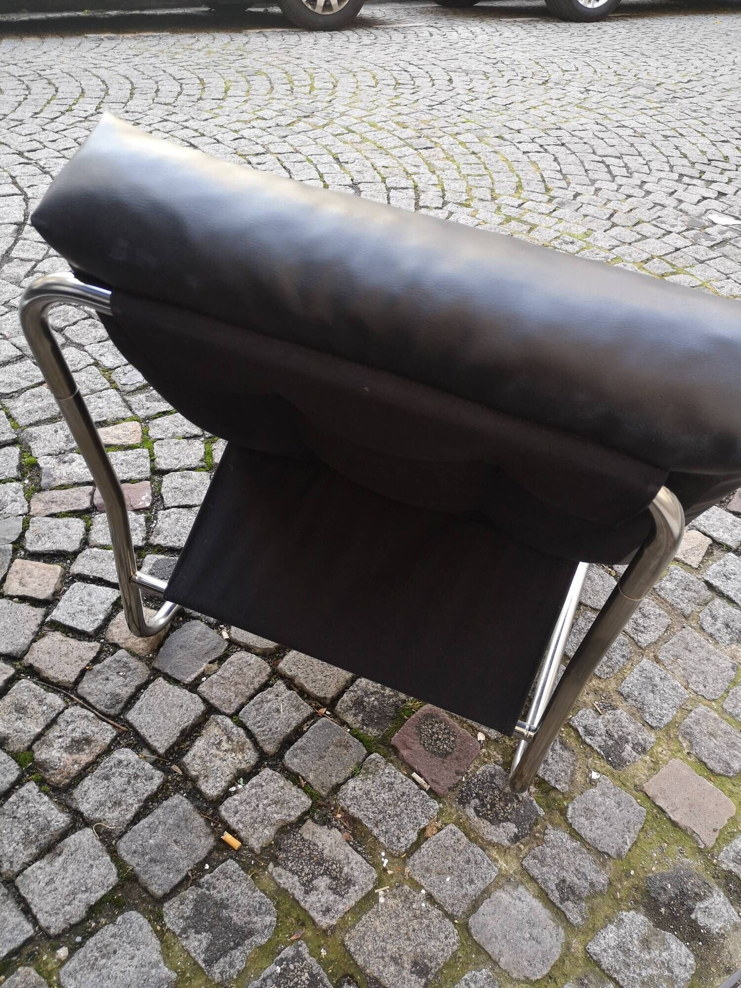 Tubular fireside chair in black skai and metal, design 1970