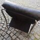 Tubular fireside chair in black skai and metal, design 1970